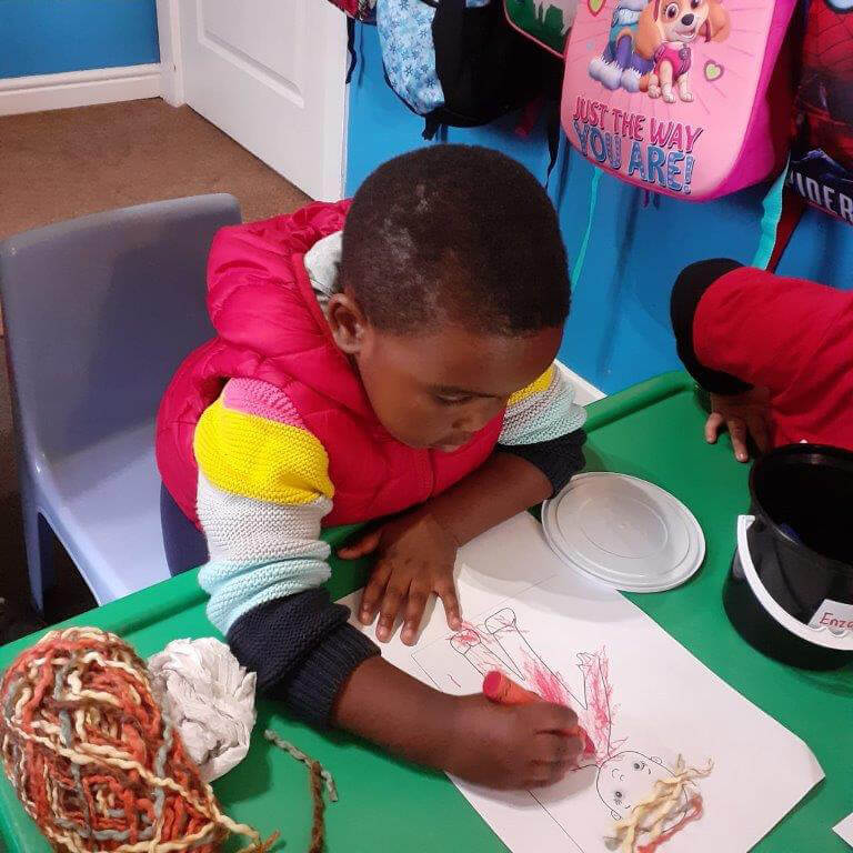 mini-minors-educare-in-queenstown-little-boy-drawing-with-crayons